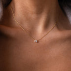 The Teardrop Garnet & Pearl Necklace features a delicate pearl strand with a garnet teardrop pendant, resting elegantly on the collarbone—an ideal milestone gift.