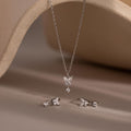 The Diamond Butterfly Drop Jewelry Set includes a silver butterfly drop necklace and matching huggie earrings, elegantly displayed on a neutral backdrop.