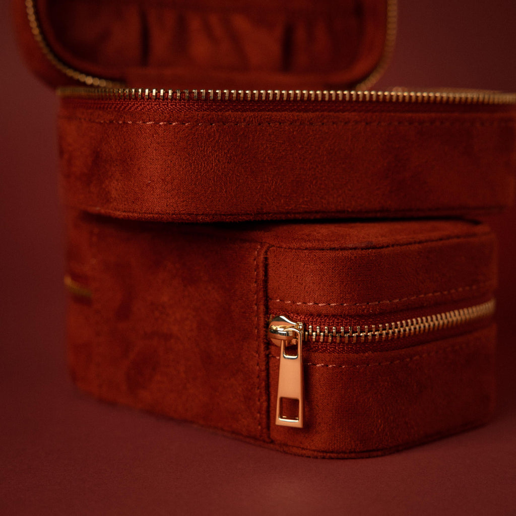 Close-up of the Cherry Red Velvet Jewelry Case with gold hardware, an elegant luxury jewelry storage solution, displayed against a matching red background.