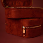 Close-up of the Cherry Red Velvet Jewelry Case with gold hardware, an elegant luxury jewelry storage solution, displayed against a matching red background.