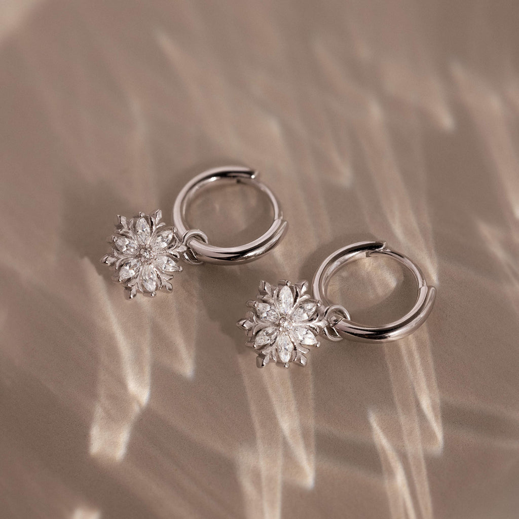 Flatlay of our Diamond Poinsettia Hoops in Silver