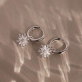 Flatlay of our Diamond Poinsettia Hoops in Silver