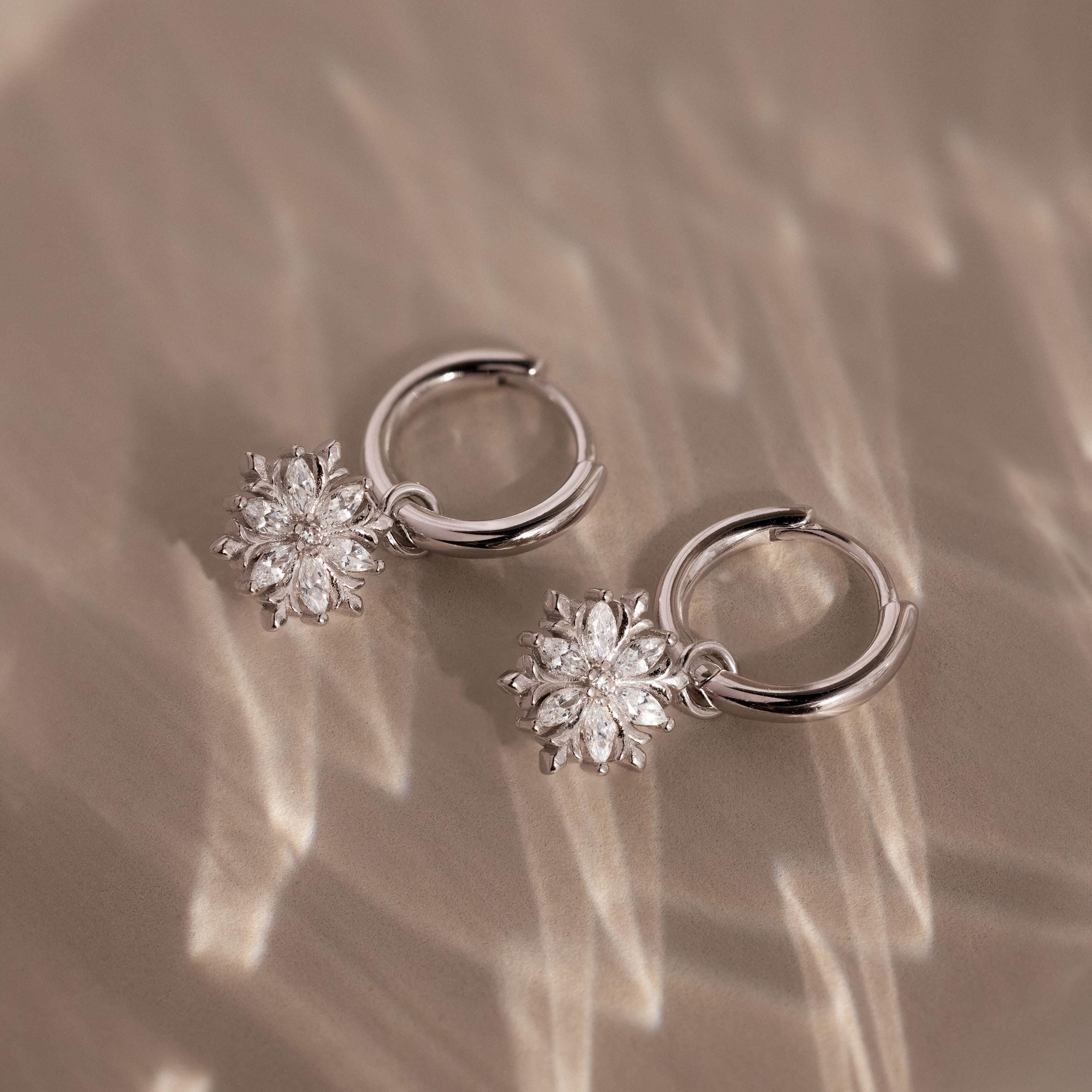 Flatlay of our Diamond Poinsettia Hoops in Silver