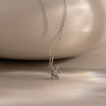 Flatlay of our Diamond Snowflake Necklace against a white bakground