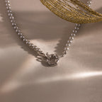 Flatlay of our Smoky Pearl Clasp Necklace