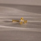 Flatlay showing our Tiny Bow Flatback Studs in 18K Gold with the flatback posts separated