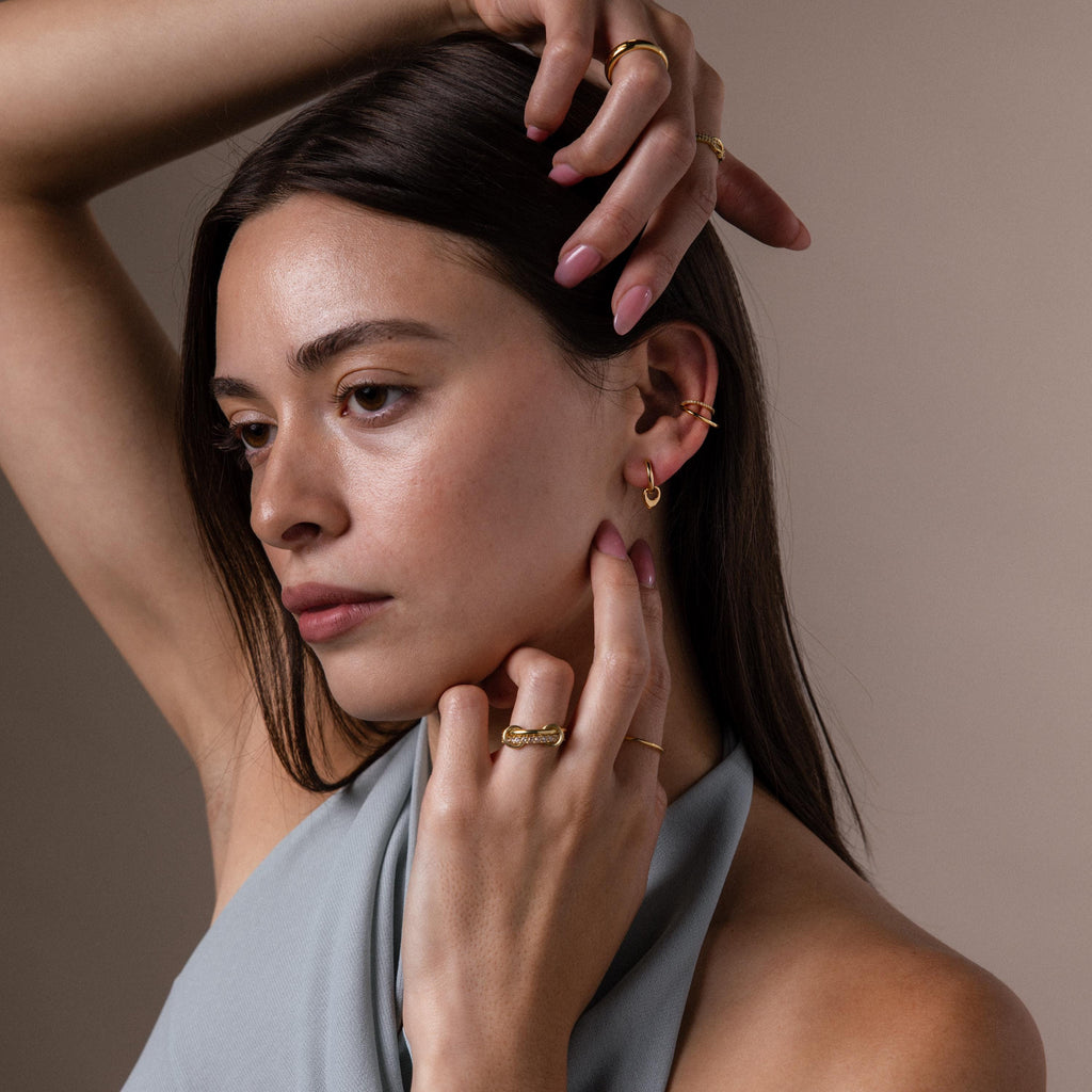 Model wearing our our Tiny Teardrop Huggies in Gold with our Lydia Duo Cuffs