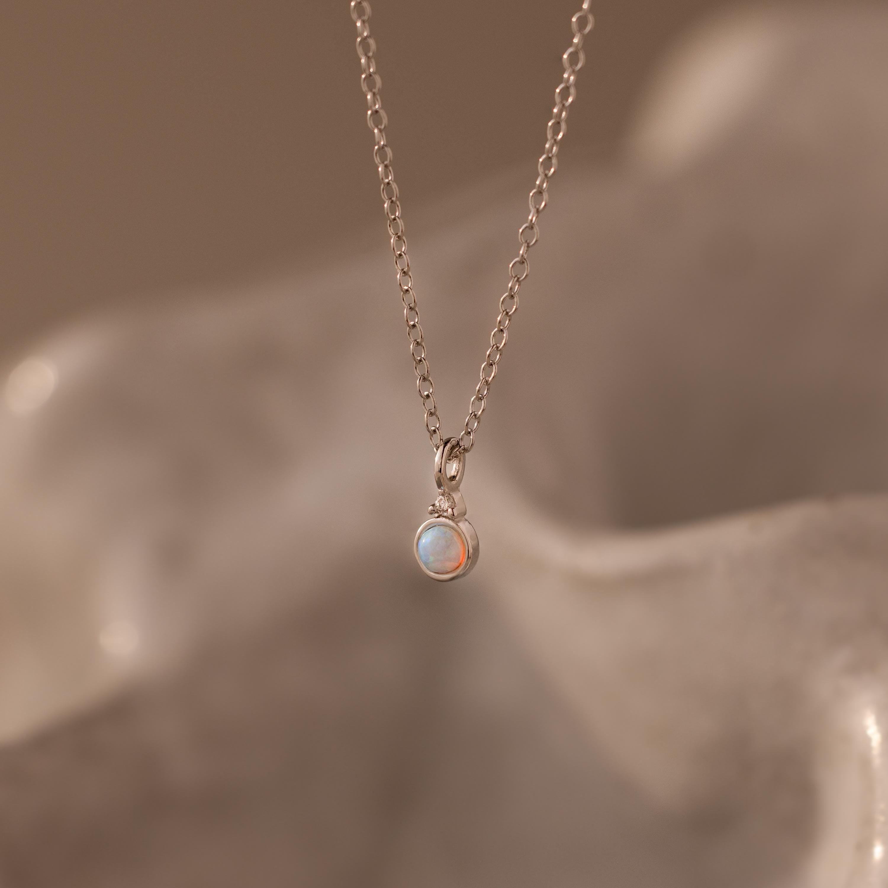 Flatlay of our Opal Diamond Necklace in Sterling Silver