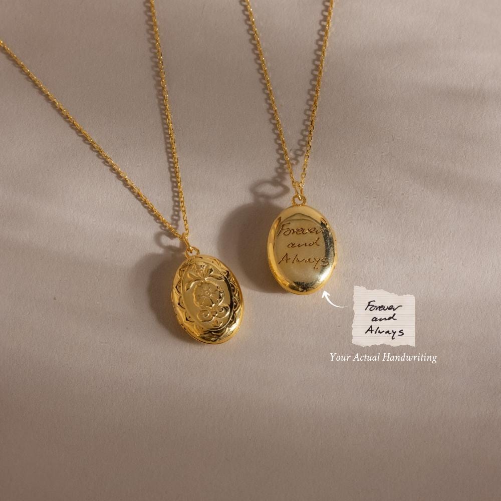The Floral Handwriting Locket Necklace in 18K Gold features two engraved lockets on chains, one inscribed with "Forever and Always" in cursive—a perfect keepsake for treasuring memories close to your heart.