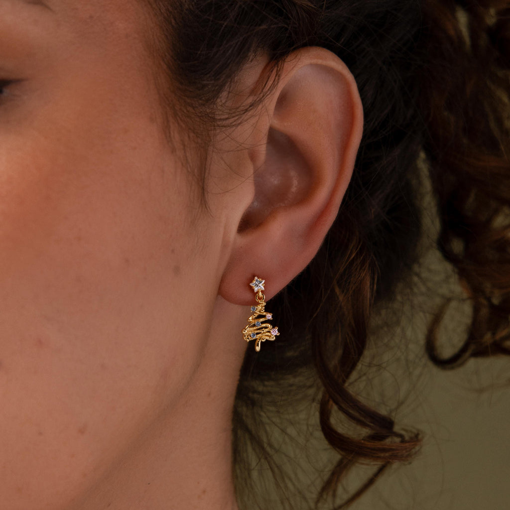 Close-up of a model wearing our Holiday Diamond Tree Studs in Gold 