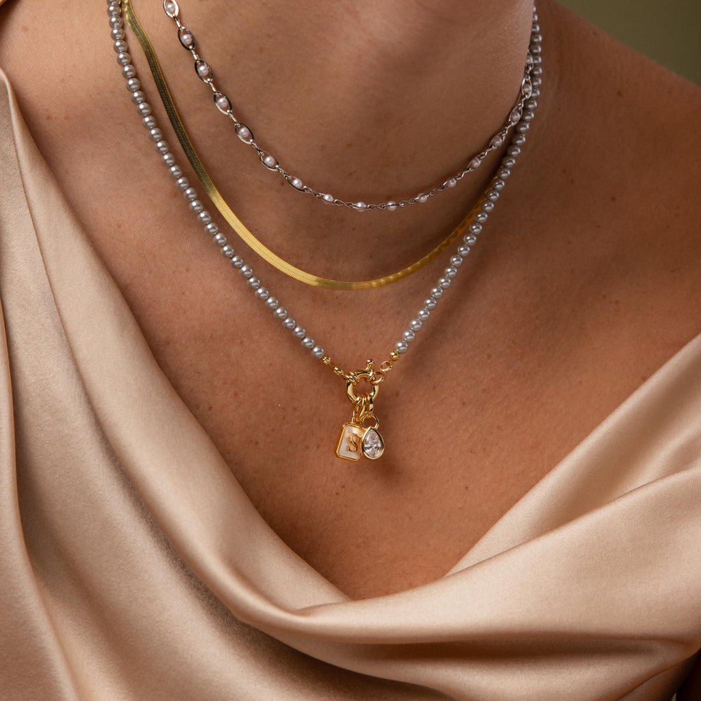 Model wearing our Smoky Pearl Clasp Necklace with our Eternity Pearl Necklace and Herringbone Necklace