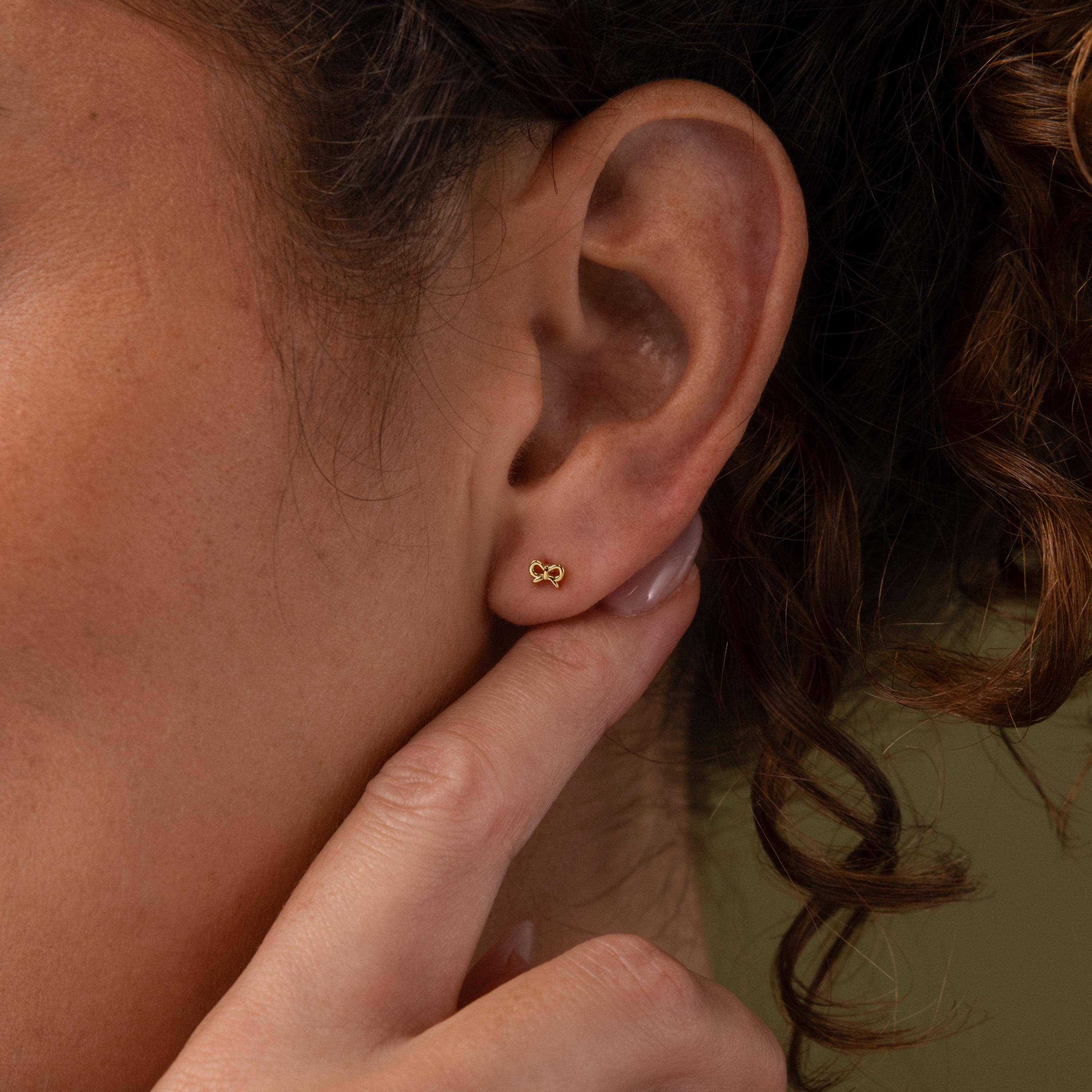 Close up of our Tiny Bow Flatback Studs in 18K Gold