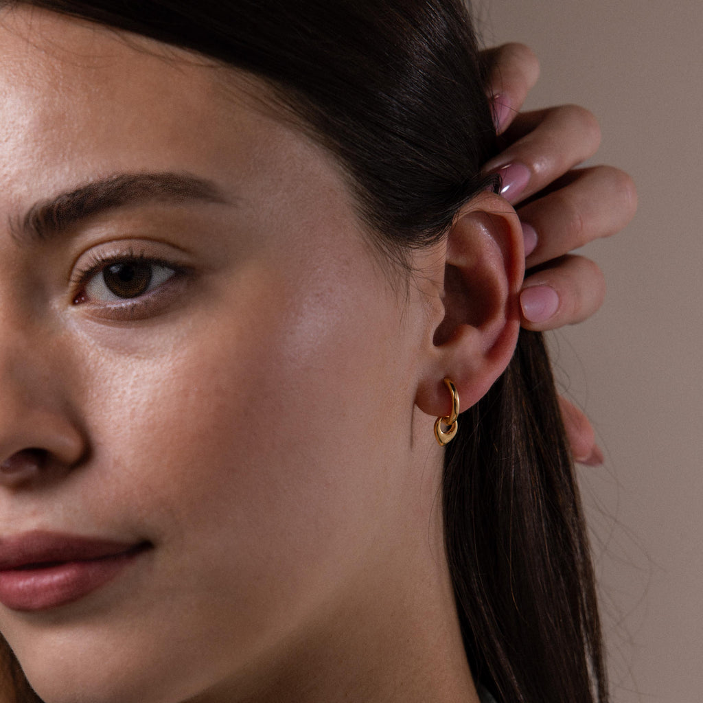 Model wearing our Tiny Teardrop Huggies in Gold