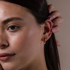 Model wearing our Tiny Teardrop Huggies in Gold