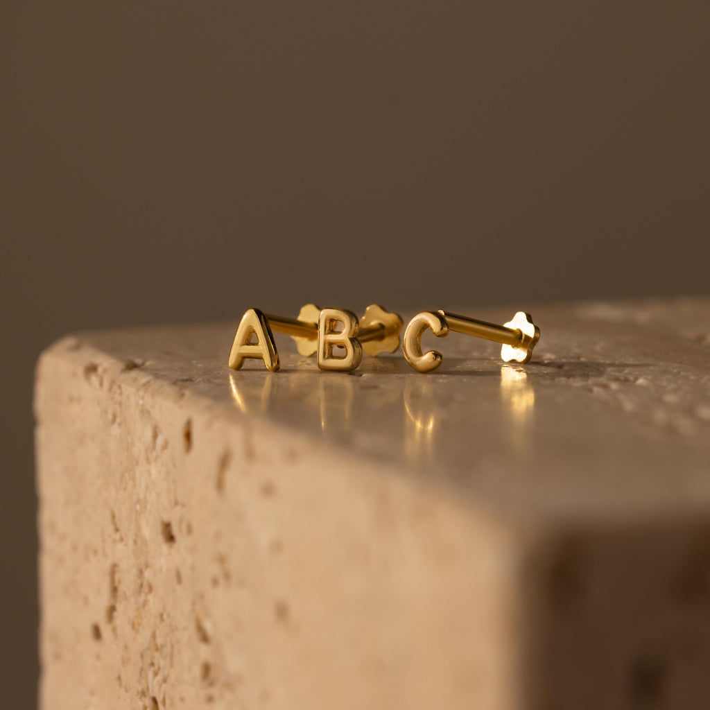 Close up flatlay of our Bubble Initial Studs with the flatback post 