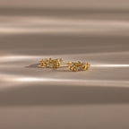 Close up flatlay image of our Diamond Leaf Hoops in 18K Gold