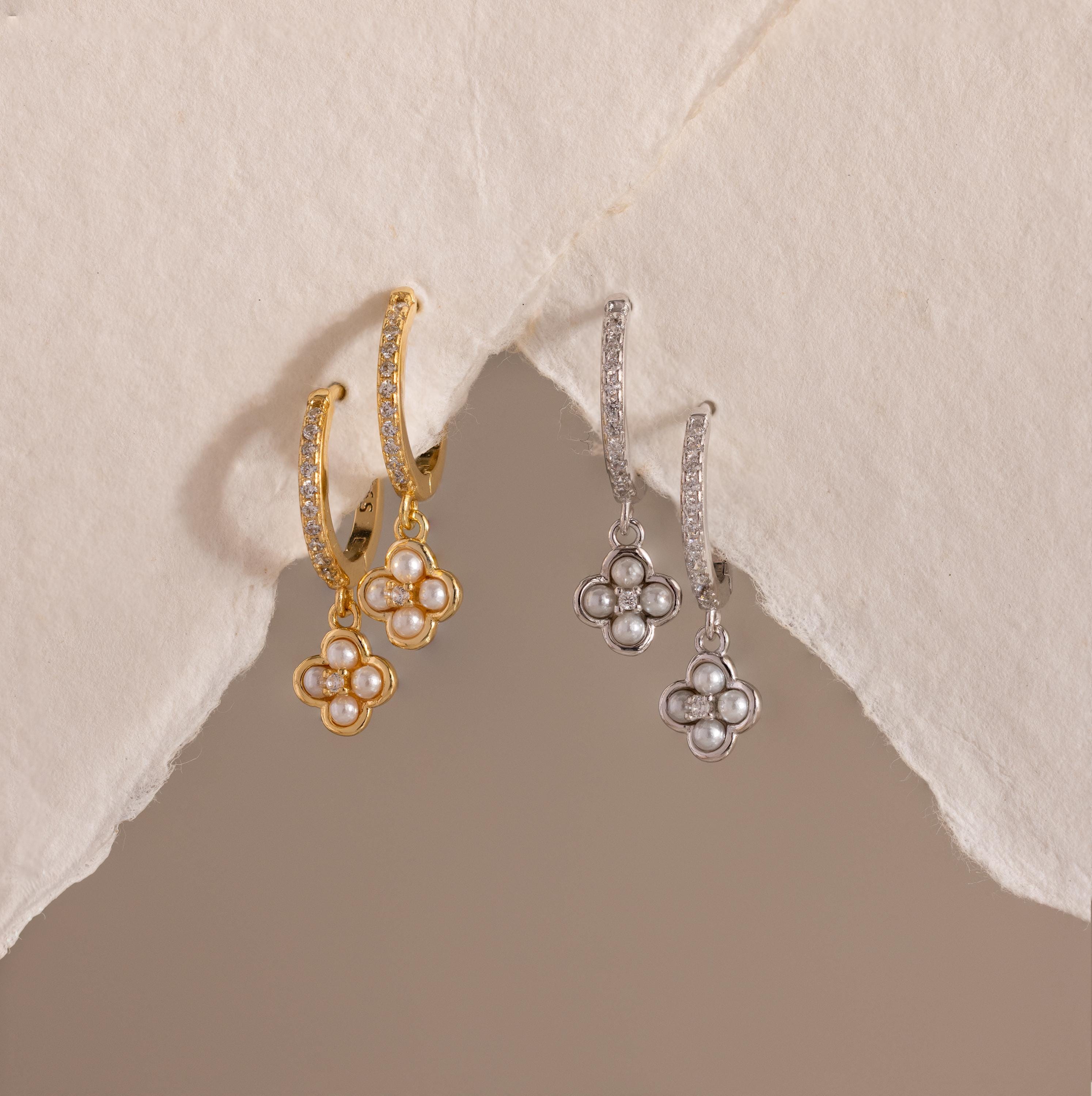 Pave Rounded Pearl Flower Hoops—gold and silver floral drop earrings with pearl centers, perfect as elegant wedding earrings—displayed on a textured off-white paper background.