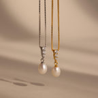 The Diamond Pearl Droplet Necklace features elegant pearls and sparkling diamonds on either a silver or gold chain, making it the perfect accessory for any occasion.