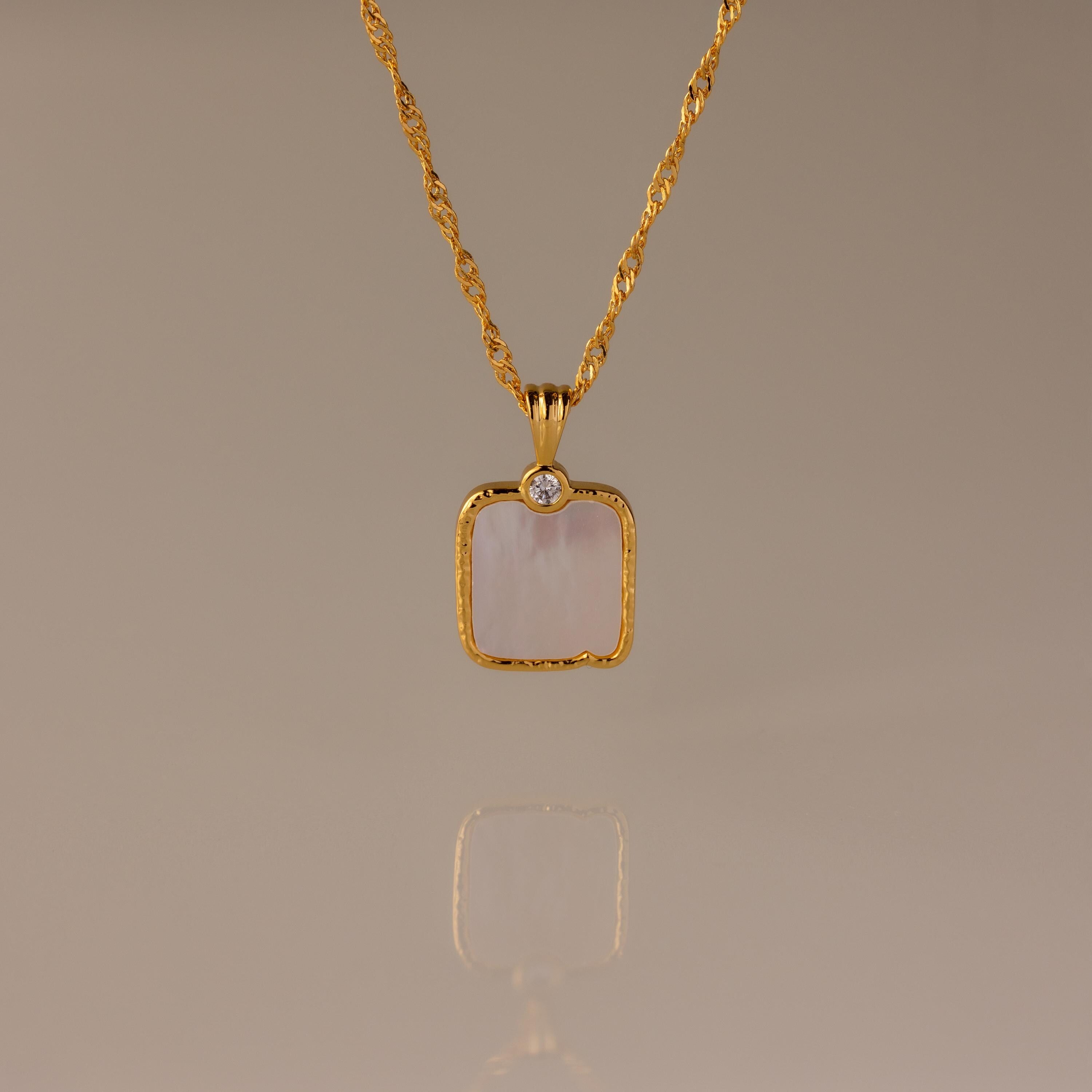 Elegant Square Mother of Pearl Necklace in 18K Gold featuring a twisted chain, a white stone pendant, and a small round gem accent.