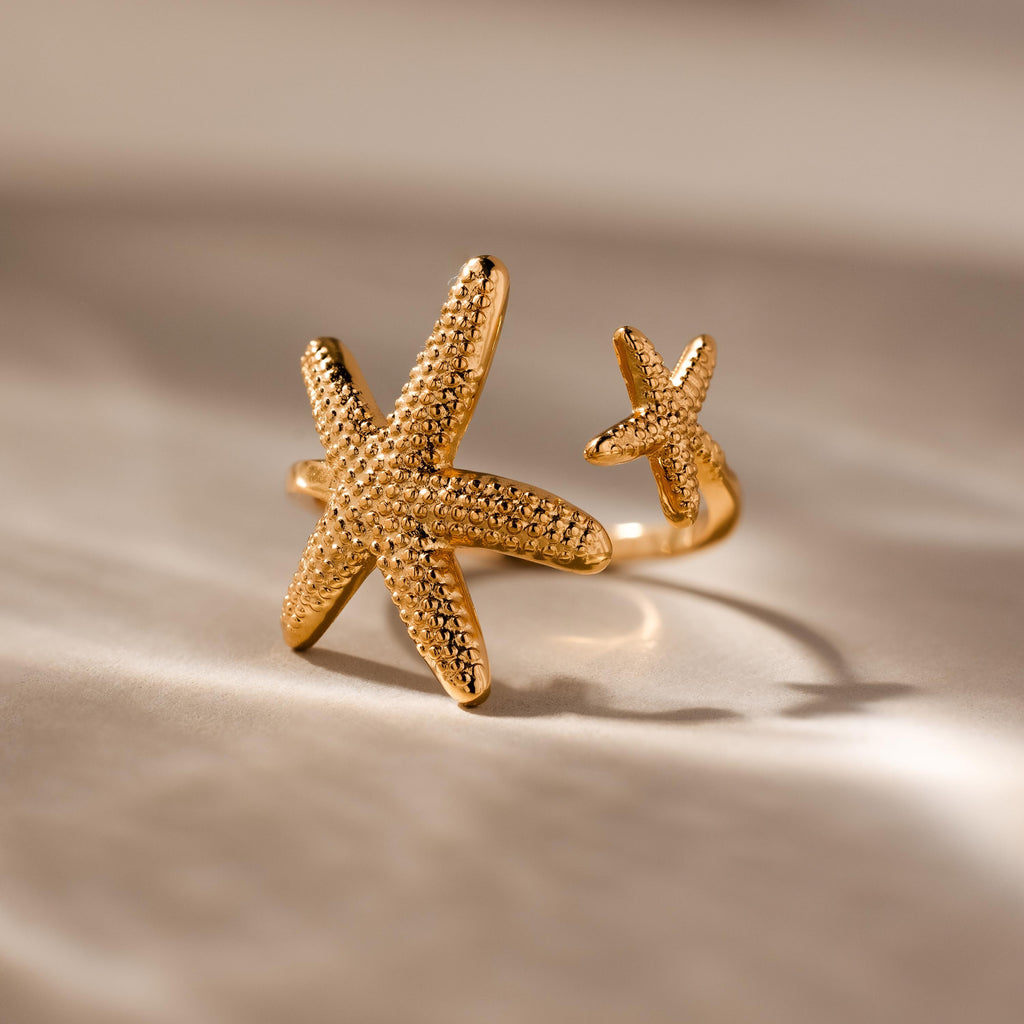 The Open Duo Starfish Ring showcases two textured starfish designs, making it a standout statement jewelry piece for any occasion.