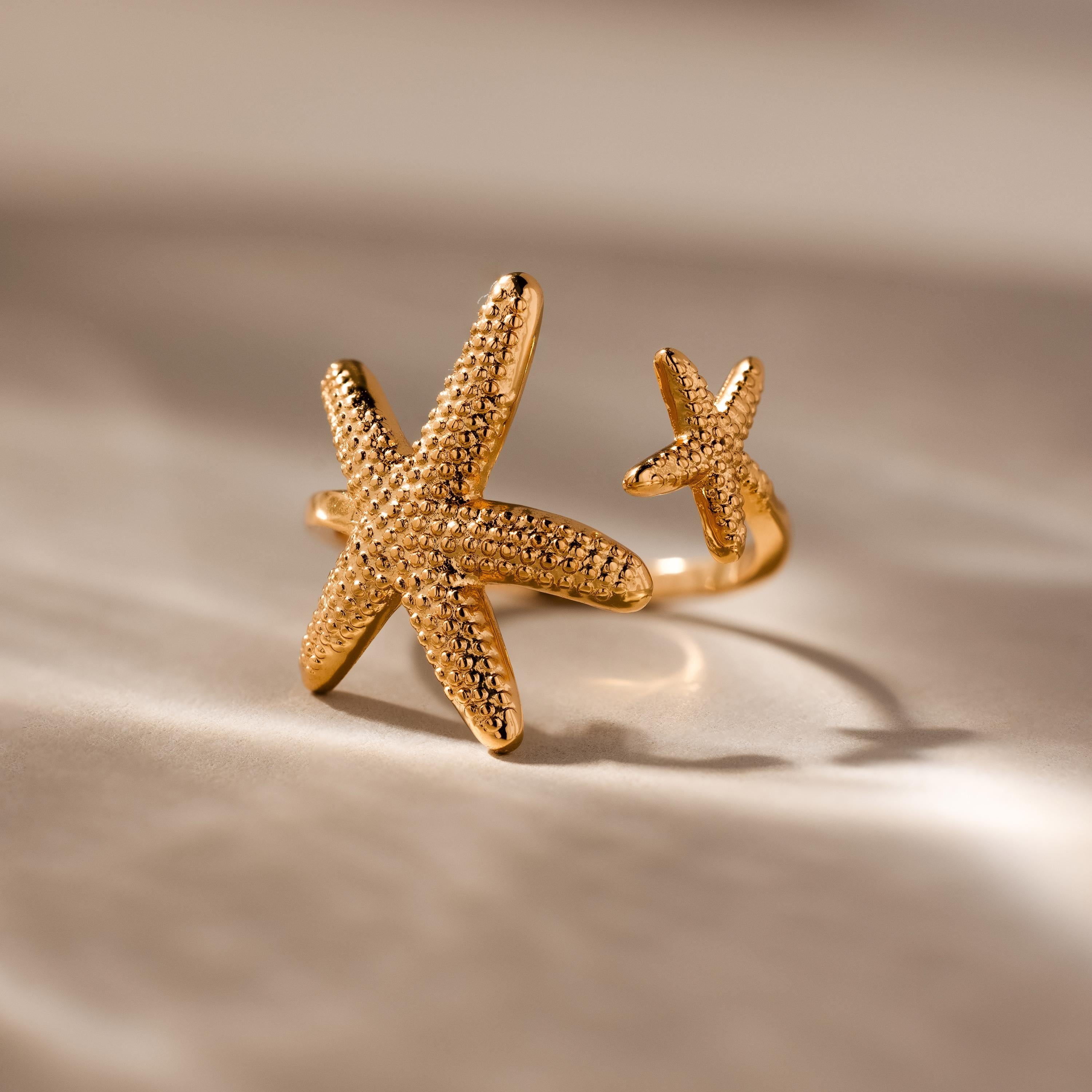 The Open Duo Starfish Ring showcases two textured starfish designs, making it a standout statement jewelry piece for any occasion.