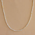 Opal Beaded Necklace showcased on a tan textured background, ideal for bringing bohemian charm to any outfit.