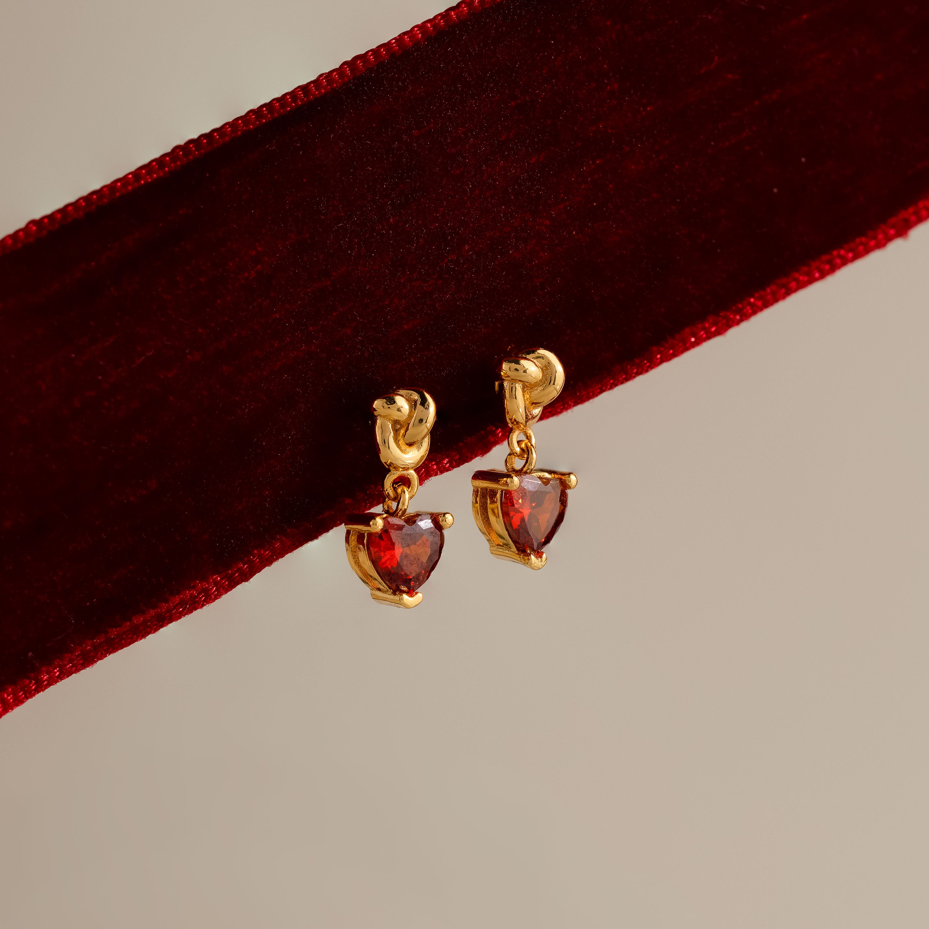 Garnet Heart Knot Studs in 18K Gold