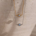 Two Opal Eye Necklaces—one in gold, one in silver—each with a blue stone center. Wear as an eye pendant or lucky talisman.