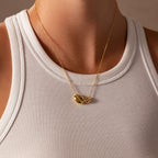 Person wearing a white ribbed tank top and minimal jewelry, featuring the Duo Pebble Necklace in 18K Gold with sculptural round pendants.