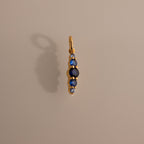 Ombre Lace Sapphire Charm pendant features five vertical blue sapphires on a neutral background with a soft shadow—ideal as a personalized charm or meaningful birth month gift.