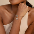 Model showcasing our Mother of Pearl Initial Charm with the letter B on our rolo bracelet