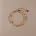 The Orbit Chain Bracelet in 18K Gold features small heart-shaped links and an adjustable clasp—an elegant piece that adds sophistication to any jewelry collection.