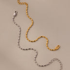 The Oval Beaded Bracelet in 18K Gold features a sleek metal chain with a lobster clasp—ideal for pairing with polished beads to add modern elegance to your jewelry collection.