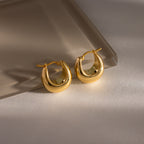 The Bold Teardrop Earrings in 18K Gold feature a chunky silhouette with a high polish finish, showcased on a neutral, softly lit surface.
