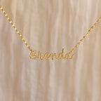 The Pave Dream Script Name Necklace features "Brenda" in elegant cursive, adorned with sparkling pavé crystals for a dazzling touch.