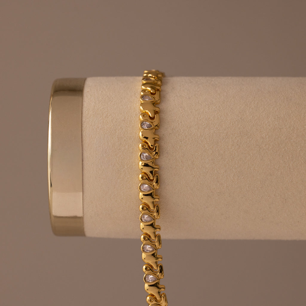 Diamond Elephant Link Bracelet featuring an intricate design with embedded white stones, displayed elegantly on a beige cylindrical holder.