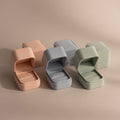 Three pastel-colored Suede Ring Boxes—pink, blue, and green—are shown open with matching closed boxes behind them, creating a chic, minimalist display.
