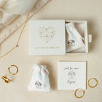 Minimalist jewelry set featuring the customizable Paperclip Chain Ring, necklace, and small pouches—all elegantly boxed and labeled Caitlyn Minimalist. Perfect for modern style lovers seeking versatile stacking rings for any look.