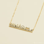 The City Skyline Necklace features a gold bar pendant with a detailed city skyline silhouette on a delicate chain—an ideal personalized gift for someone special.