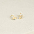 The Aeon Studs feature gold constellations with crescent moons, star shapes, and sapphire accents that bring celestial charm to any neutral backdrop.