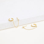 Pave Chain Ear Cuffs featuring delicate chains and sparkling crystals, showcased on a white textured surface.