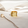 Four Ann Thin Message Rings engraved and stacked on white fabric, paired with a dried plant stem in soft natural light—a timeless personalized set, perfect as a thoughtful holiday gift.