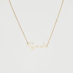 The Summer Name Necklace features a gold chain with a personalized pendant that spells "Sarah" in an elegant script font—perfect for any occasion.