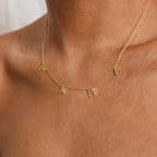The Mama Letter Necklace displays "MAMA" in gold letter charms on your neck—a thoughtful gift to celebrate motherhood.