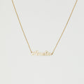 The Mellow Name Necklace features a gold chain and a pendant spelling "Amelia" in elegant cursive, making it an ideal personalized necklace for any special occasion.