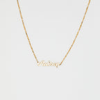 The Mellow Name Necklace in Box Chain features "Aubrey" in elegant cursive on a slim box chain, shown against a white background.