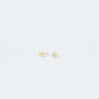 Pave Round Studs feature small, round gold settings encrusted with sparkling crystals, adding a touch of glam to any look on a plain white background.