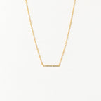 The Pave Bar Necklace features a gold chain with a petite, sparkling bar pendant—ideal for adding subtle shine to your look or layering with other necklaces.