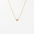 The Pave Round Necklace features a gold chain with a small, pavé-encrusted circle pendant, shown on a plain white background.