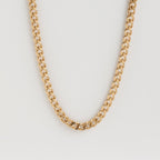 Isolated shot of the gold curb chain necklace against a white background.